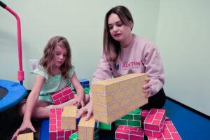 parent playing with her daughter